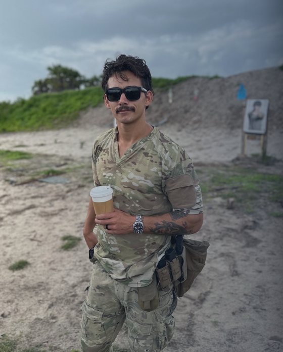 Jack Chinchay in multicam at the range, coffee in hand